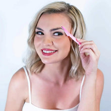 Woman holding a pink eyebrow razor to shape her eyebrows