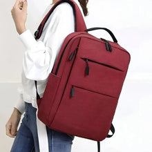Red waterproof travel backpack with shoulder straps and side front zipper pocket