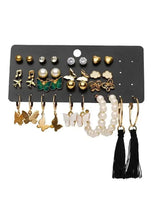 Multi-style earring set with butterfly charms, pearls, and black tassel hoops