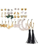 Earring set with assorted studs, gold butterfly hoops, pearl strands, and black tassels