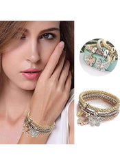 Huitich butterfly charm bracelet set with gold and silver tones worn on model wrist and displayed separately