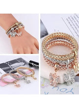 Braided charm bracelet set with crystal butterfly charms, styled on wrist