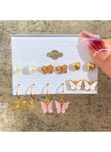 Earring set on display card: gold-toned hearts, butterflies, pearls, and pink drop pairs