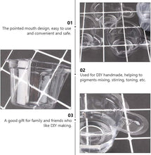Clear plastic cup with pointed pour spout, close-up showing transparent measuring area