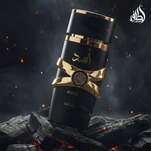 Eau de Parfum bottle with black cylinder body and gold cap with ring accents