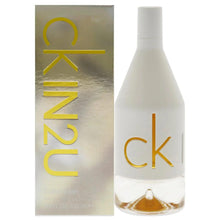 Perfume bottle with CK gold logo beside IN2U her box