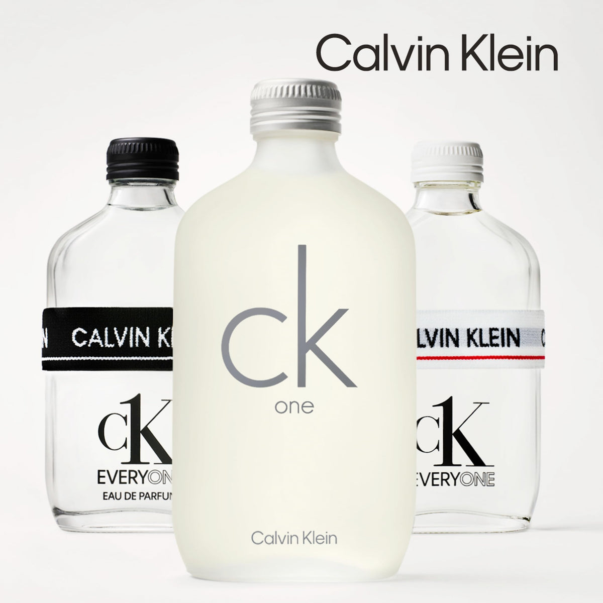 CK One unisex Eau De Toilette 200ml frosted bottle in front of two clear Calvin Klein bottles