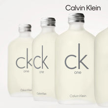 Three cream eau de toilette bottles with silver caps and CK One labels