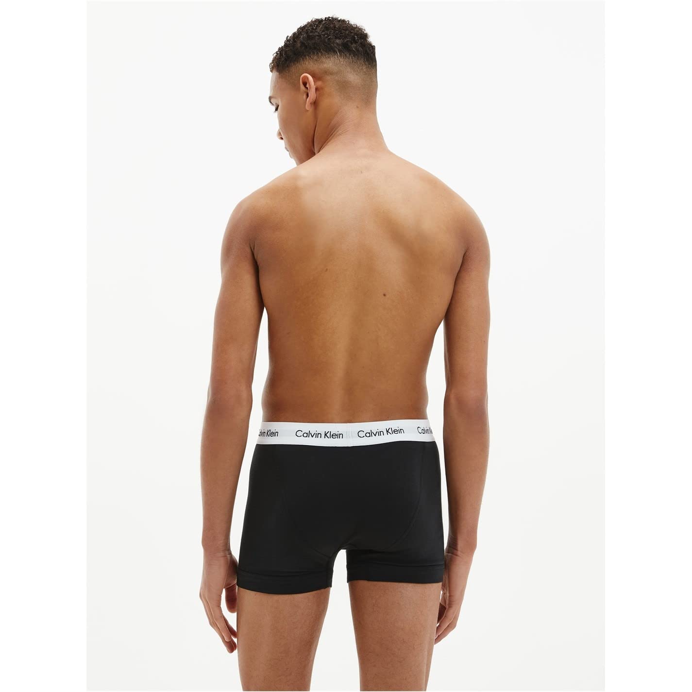 Back view of a man wearing black cotton boxer briefs 3 pack with Calvin Klein branded waistband