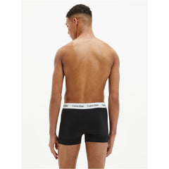 Back view of a man wearing black cotton boxer briefs 3 pack with Calvin Klein branded waistband