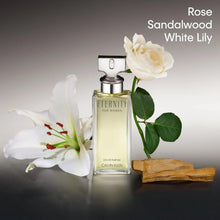 Calvin Klein Eternity Eau de Parfum bottle with white lily, white rose, and wood piece