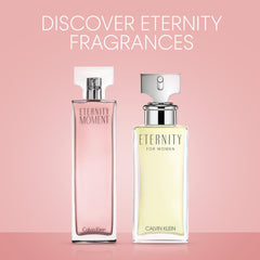 Calvin Klein Eternity Moment perfume bottle next to Eternity for Women perfume on pink background