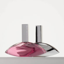 Eau de parfum bottle with matching box, clear-pink glass and shiny dark cap