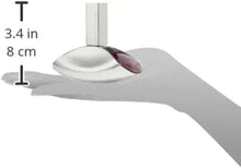 Curved perfume bottle on a hand, silver glass with dark purple interior accents