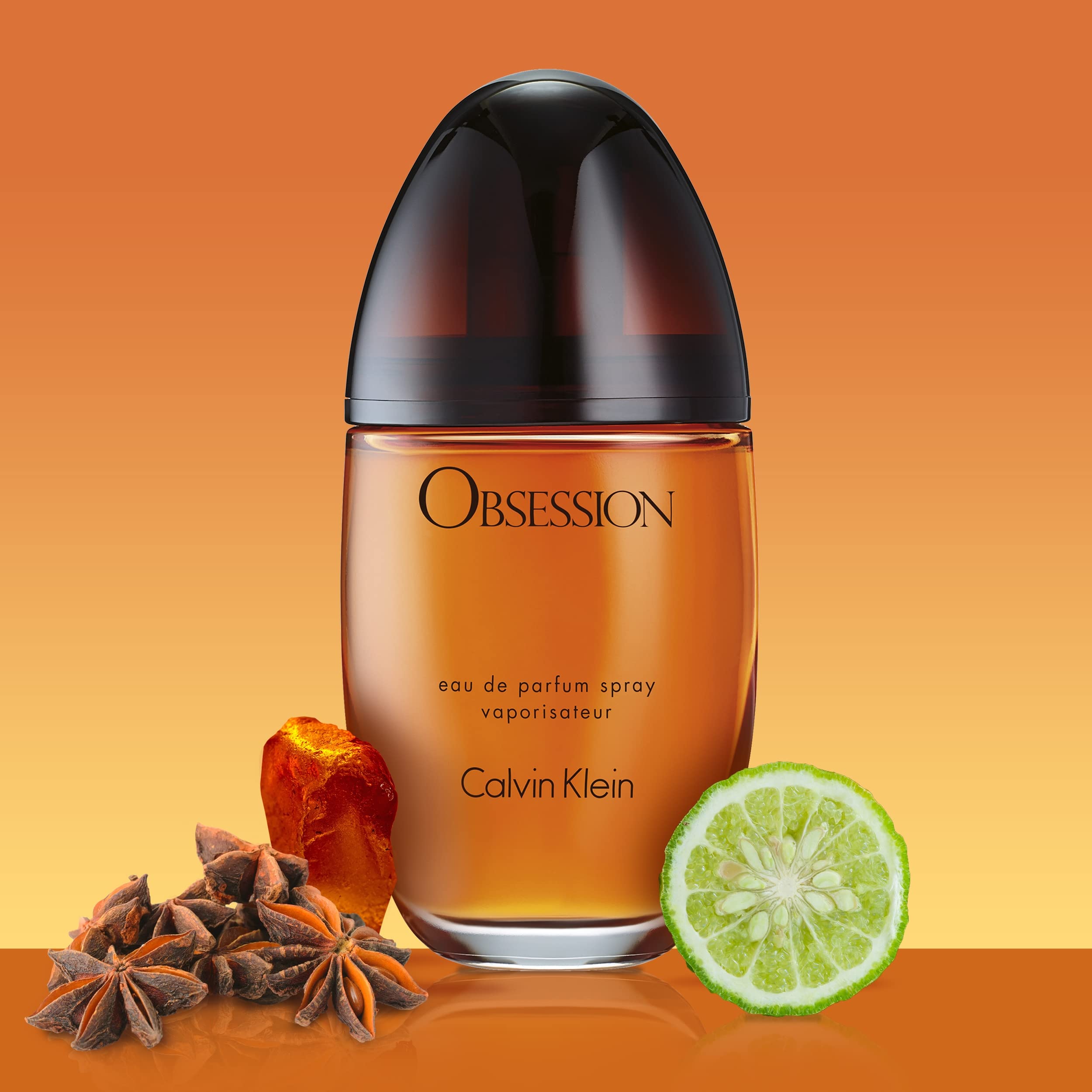 Calvin Klein Obsession perfume for women in an elegant bottle surrounded by spices and lime slice