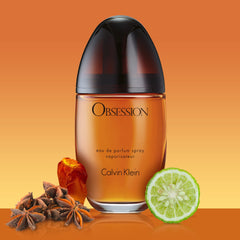 Calvin Klein Obsession perfume for women in an elegant bottle surrounded by spices and lime slice