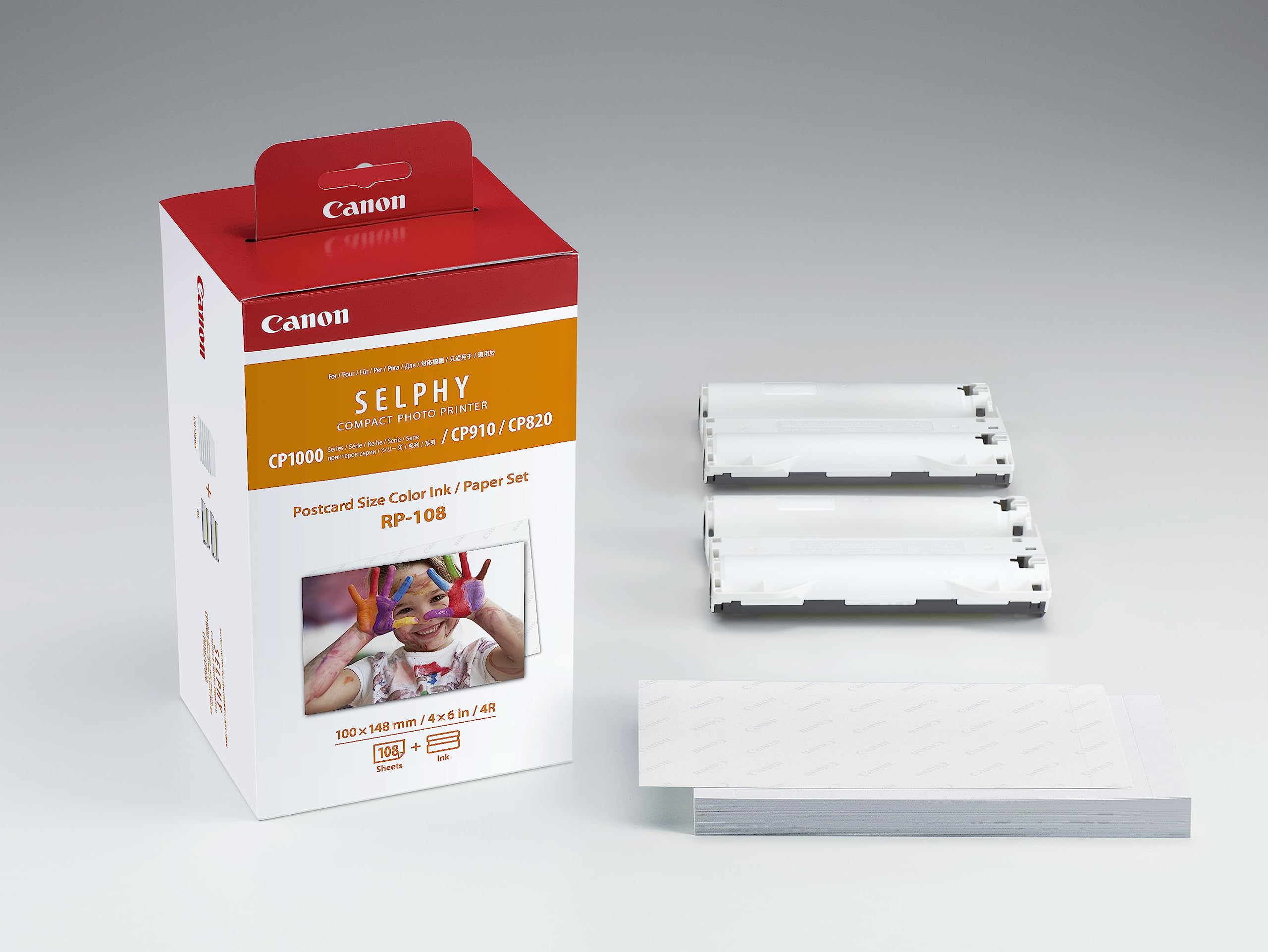 Canon RP108 ink and paper set with three ink cartridges and a stack of photo paper for SELPHY printers