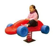 Car-shaped kids rocking chair with red body, blue wheels; child seated on it.
