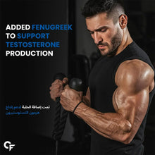 Muscular man holding dumbbells in a gym while wearing a black t-shirt