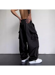 Black cargo style wide leg pants for ladies with multiple pockets worn with white sneakers