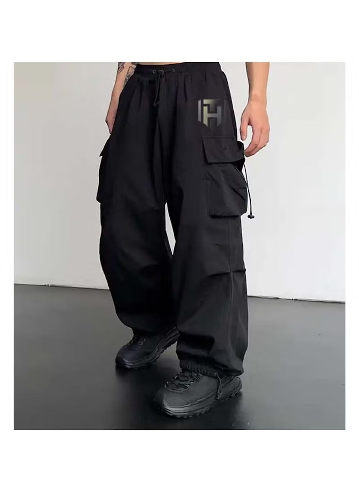 Black cargo style wide leg pants for ladies with multiple pockets and adjustable waist drawstring