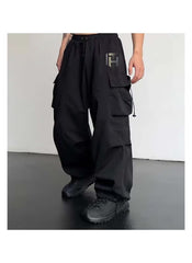 Black cargo style wide leg pants for ladies with multiple pockets and adjustable waist drawstring