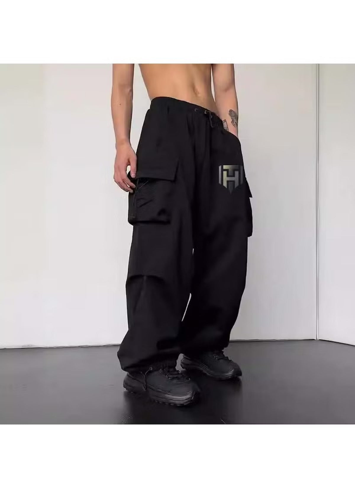 Black cargo style wide leg pants for ladies with multiple pockets and drawstring waist
