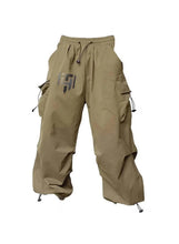 Beige wide-leg cargo pants with drawstring waist and side flap pockets