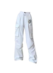 White cargo style wide leg pants for ladies with large side pockets and elastic waistband