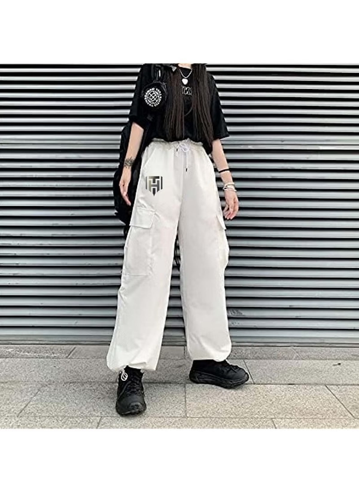 White cargo style wide leg pants for ladies styled with black t-shirt and sneakers