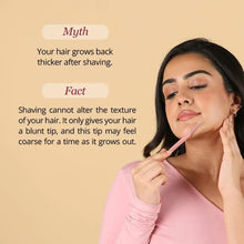 Woman holding a pink facial razor near her chin