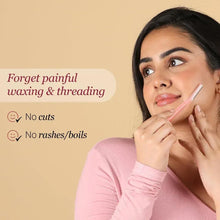 Woman holding a pink facial razor near her upper lip area