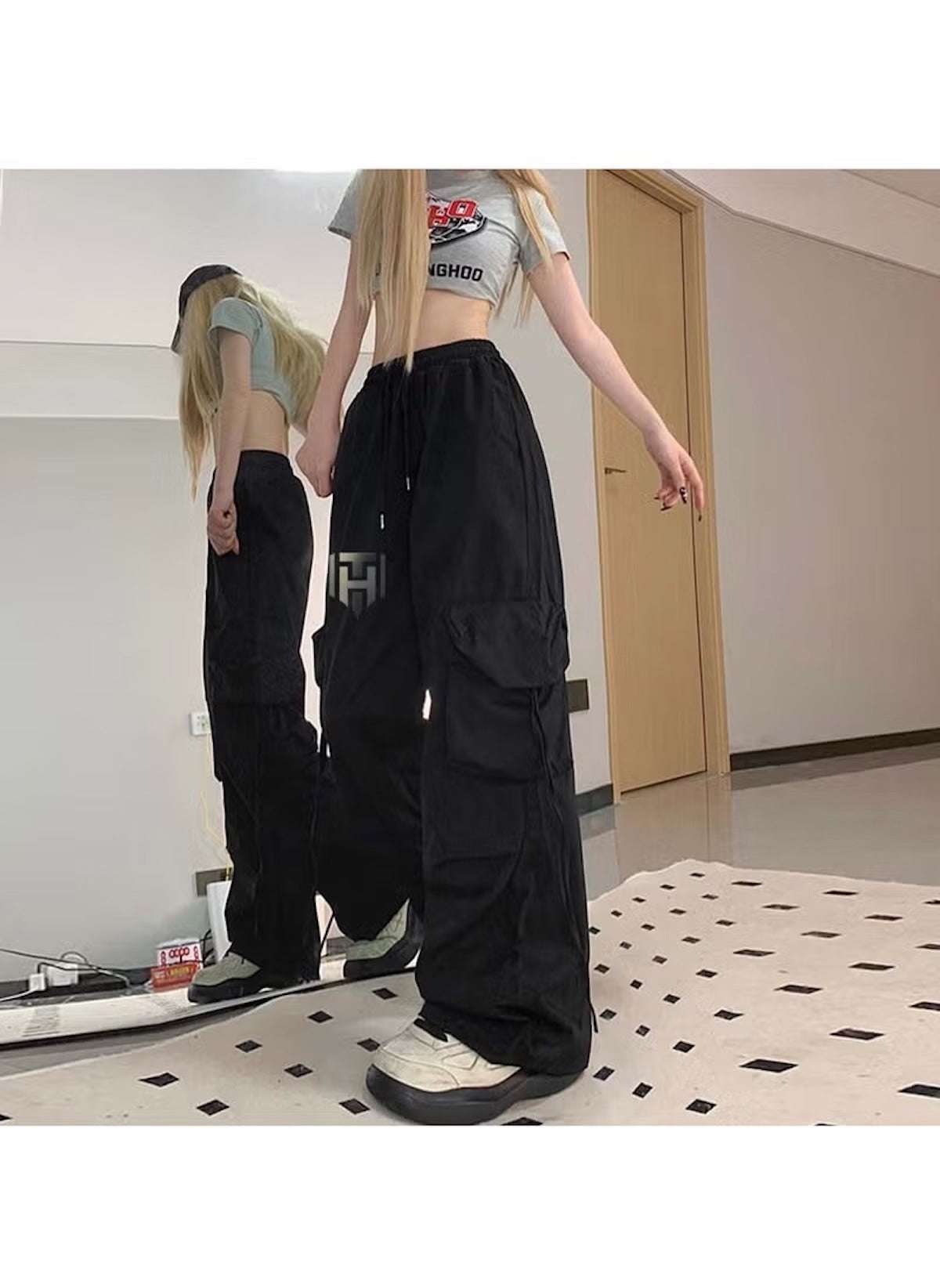 Huitich casual black pants for office wear styled with a crop top and white sneakers indoors