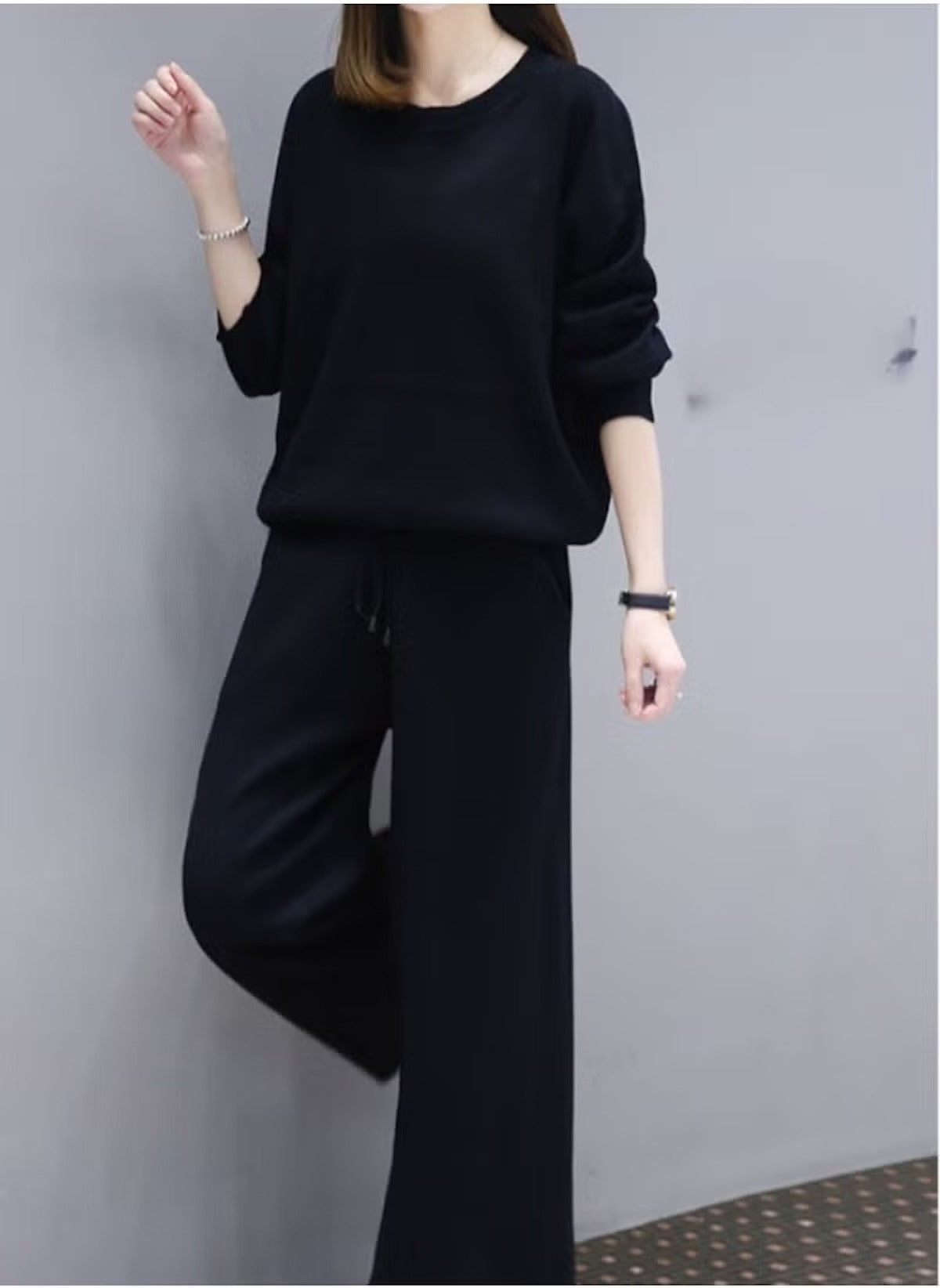 Black casual two-piece suit for women featuring a loose long-sleeve top and wide-leg pants