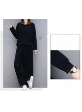 Women’s black two-piece casual suit with long-sleeve top and wide-leg pants, wrist detail