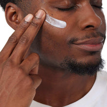 Man applying gel moisturizer to cheek and jaw