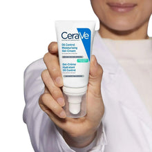 Hand holding oil control gel-cream tube