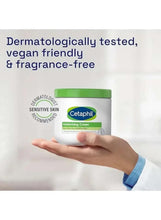 Cetaphil moisturizing cream jar held in a hand, green lid visible