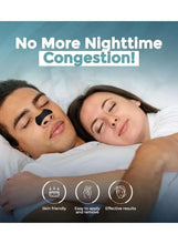 Black nasal strips applied on sleeping faces for night congestion relief