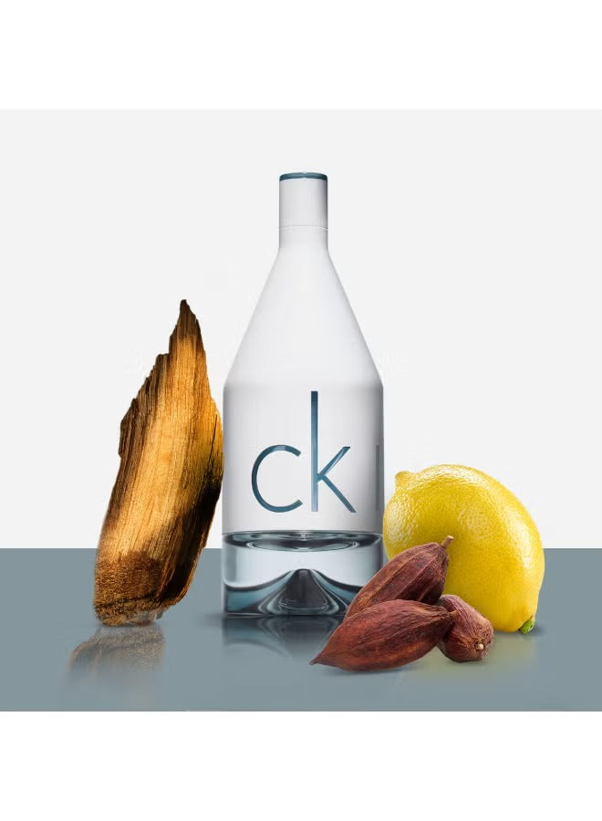 CK IN2U perfume for men in a sleek bottle with wood, lemon, and spice elements for a fresh scent