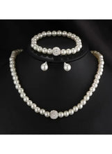 Faux pearl jewelry set: pearl necklace, bracelet, and drop earrings
