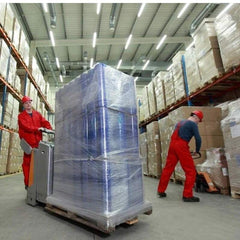 Warehouse workers using clear pallet wrapping roll 50cm to secure items on pallets in storage facility