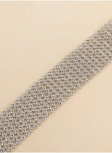 Crystal rhinestone choker necklace close-up, silver-toned rings with clear stones