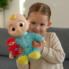 Stuffed baby doll in light blue patterned outfit with yellow feet, held by a child