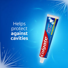 Colgate cavity protection toothpaste tube on blue background labeled helps protect against cavities