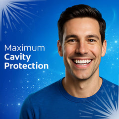 Smiling man showing bright teeth with Colgate cavity protection toothpaste advertisement on blue background