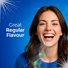 Smiling woman with bright teeth against blue background promoting Colgate cavity protection toothpaste with fresh mint leaves