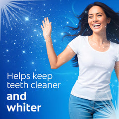 Smiling woman on blue background promoting Colgate cavity protection toothpaste for cleaner whiter teeth