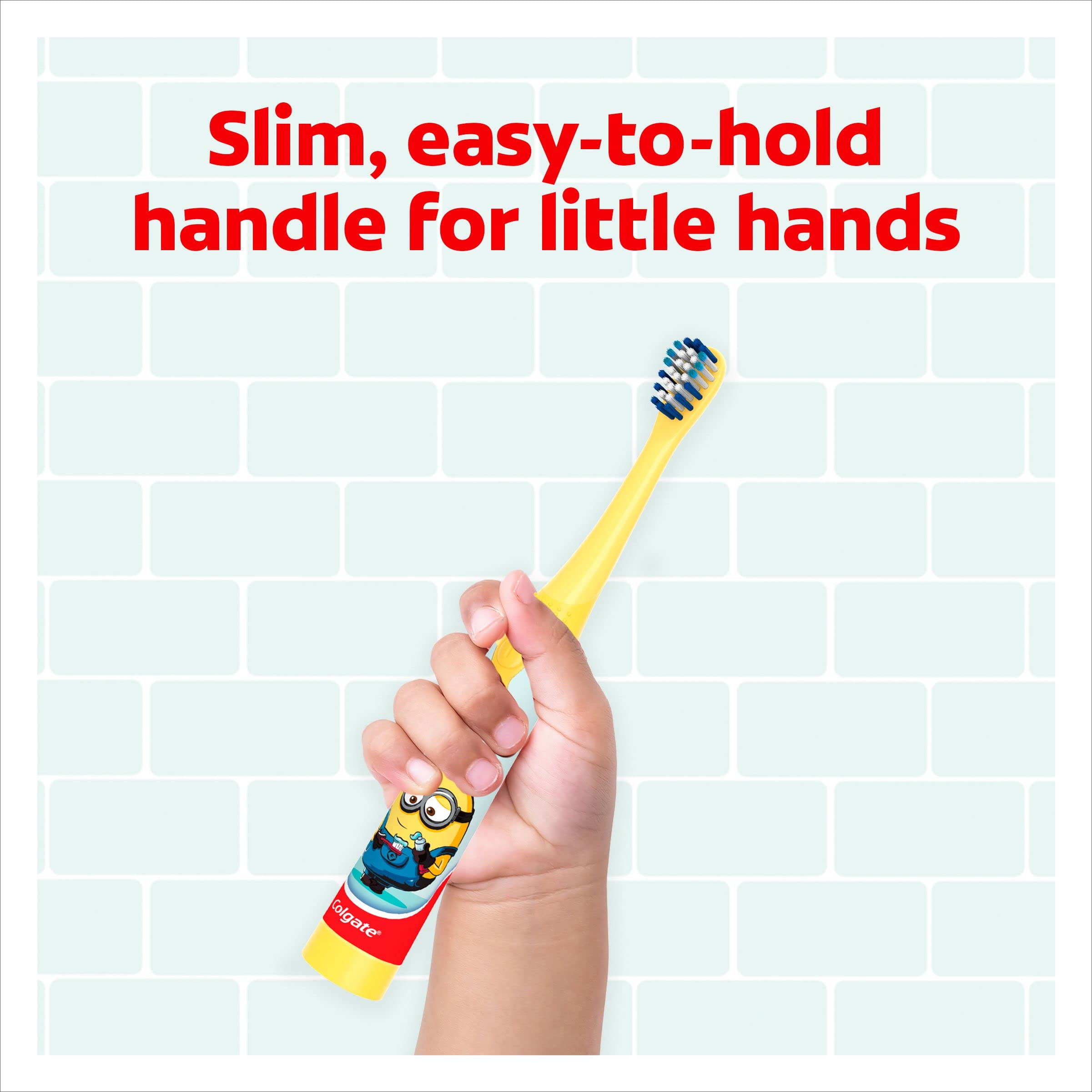 Child hand holding Colgate kids Minions toothbrush with slim yellow handle and blue bristles