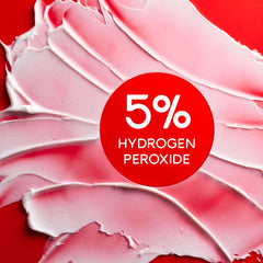 Colgate optic white pro series toothpaste whitening paste smear on red background highlighting 5 percent hydrogen peroxide